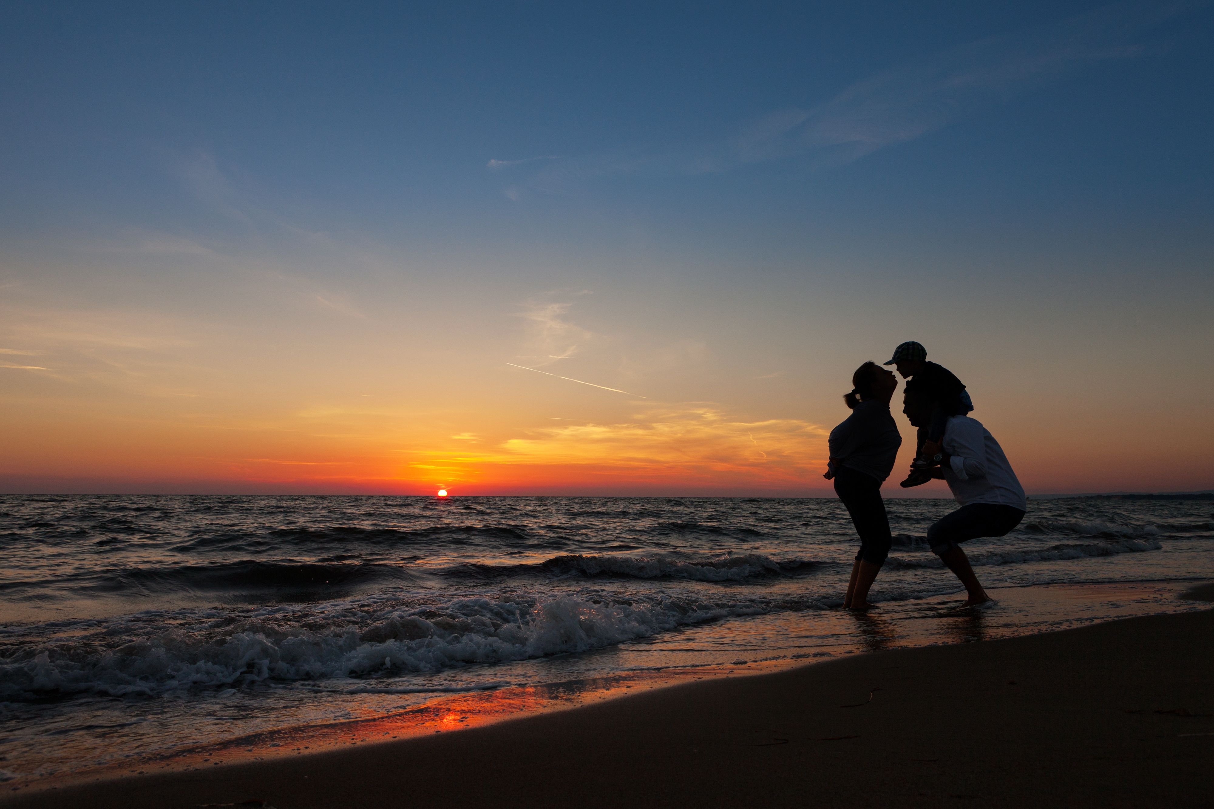 family at a 30a beach at sunset during fall