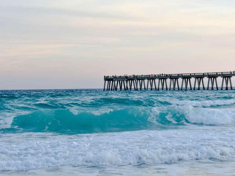 Ocean waves and view of Navarre Beach Pier